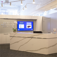 The entrance to Design Resource center, featuring an Arabescato quartz (Vicostone) concierge desk.