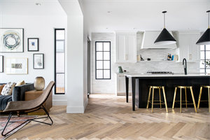 A modern farmhouse residence with Vernazza European oak herringbone hardwood from the Farmhouse Collection by Divine. Photo credit: Trickle Creek Homes.